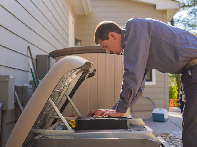 A CK Power technician installing a residential generator at a suburban home